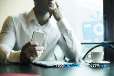 Businesman With Smartphone In Cafe Stock Photo