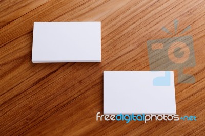 Business Card Mockup On Wood Desk Stock Photo