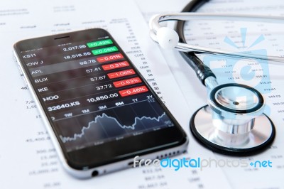 Business Concept. Financial Analysis, Smartphone And Stethoscope… Stock Photo