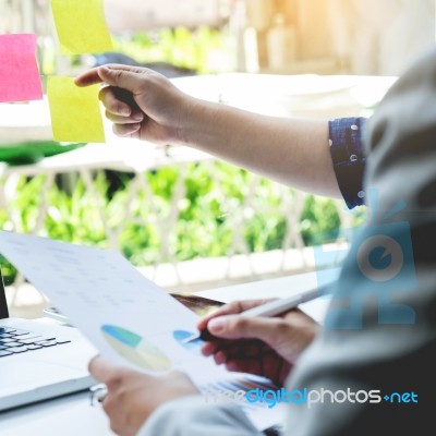 Business Discussing Documents And Ideas At Meeting Stock Photo