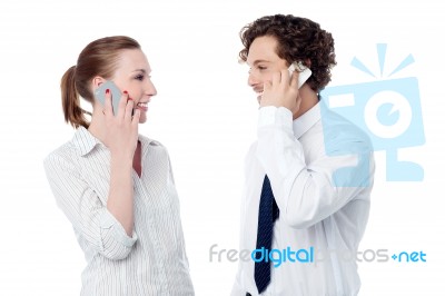 Business Executives Engaged Over A Phone Call Stock Photo