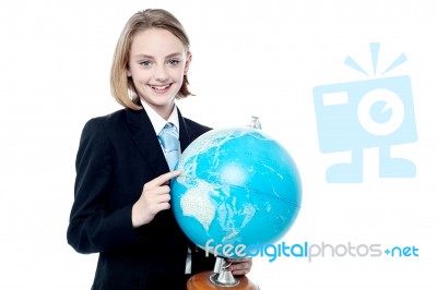 Business Girl Indicating A Place In Globe Map Stock Photo