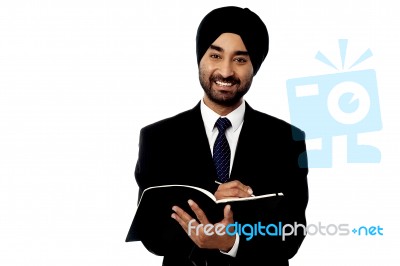 Business Guy Writing Down Key Points Stock Photo