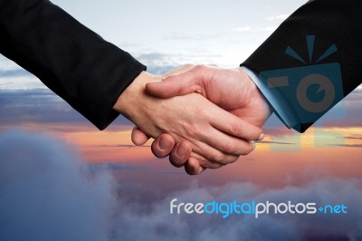 Business Handshake On A Sky Background Stock Photo