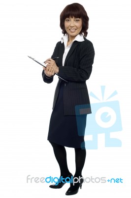 Business Lady Writing On Clipboard Stock Photo