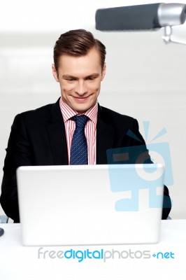 Business Male Watching Videos On Laptop Stock Photo