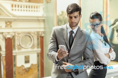 Business Man And Business Reading A Text Message Stock Photo