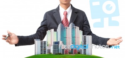 Business Man And Modern Building On Green Grass Field Stock Photo