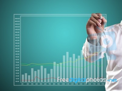 Business Man Hand Drawing A Graph Stock Photo