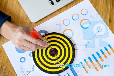 Business Man Hand Holding A Target With Darts Hitting The Center… Stock Photo