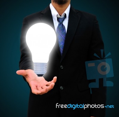 Business Man Holding Light Bulb Stock Photo