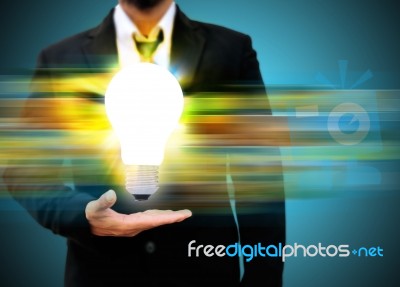 Business Man Holding Light Bulb Stock Photo