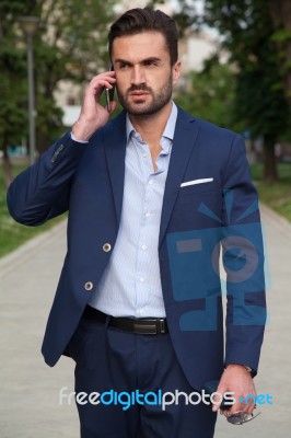 Business Man On The Street And Mobile Phone Stock Photo