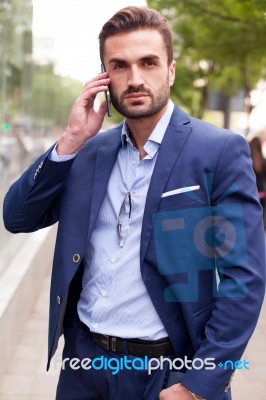 Business Man On The Street And Mobile Phone Stock Photo