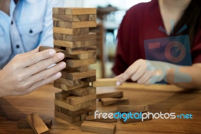 Business Man Placing Wooden Block On A Tower Concept Of Risk Con… Stock Photo