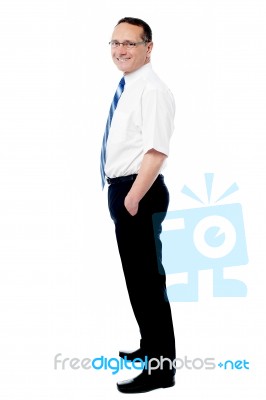 Business Man Standing With His Hands In The Pockets Stock Photo