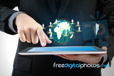 Business Man Using A Touch Screen Device With Social Network Stock Photo