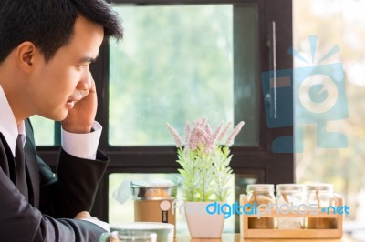 Business Man Using Mobile Phone While Sitting In The Coffee Shop… Stock Photo