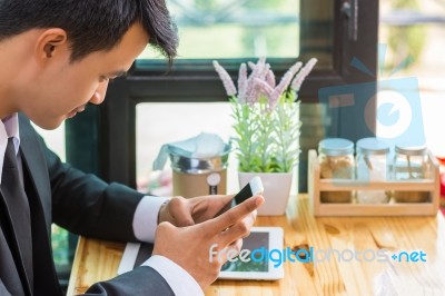 Business Man Using Mobile Phone While Sitting In The Coffee Shop… Stock Photo