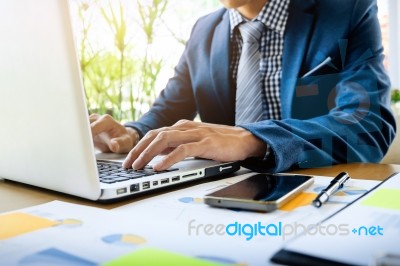 Business Man Working At Office With Laptop, Tablet And Graph Dat… Stock Photo