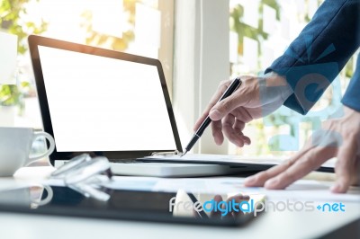 Business Man Working At Office With Laptop, Tablet And Graph Dat… Stock Photo