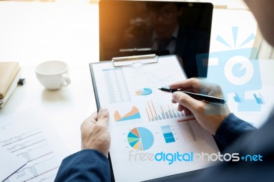 Business Man Working At Office With Laptop, Tablet And Graph Dat… Stock Photo