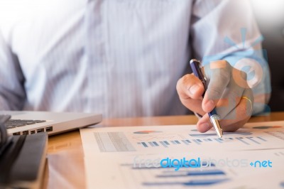 Business Man Working At Office With Laptop, Tablet And Graph Dat… Stock Photo