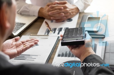 Business Man Working At Office With Laptop, Tablet And Graph Dat… Stock Photo