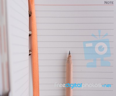 Business Notebook And Brown Pencil Stock Photo