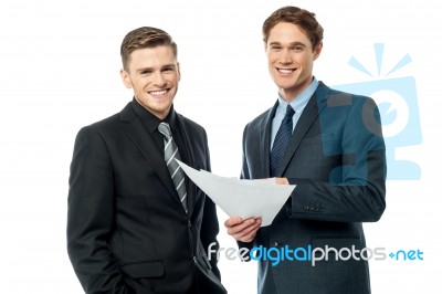 Business Partners Discussing Reports Stock Photo