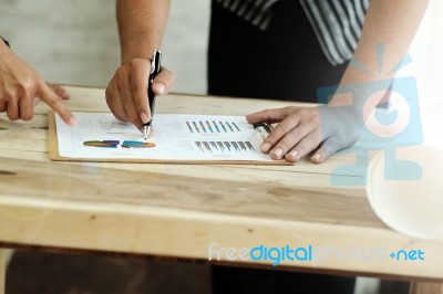 Business People Discussing The Charts And Graphs Stock Photo