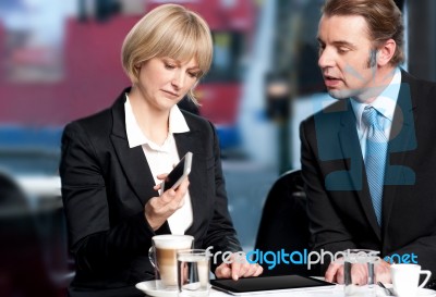 Business People Having Discussion At Cafe Stock Photo