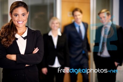 Business Woman Posing With Smart Associates Behind Stock Photo