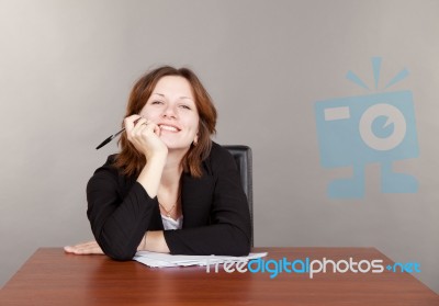 Business Woman Sitting At The Table Stock Photo