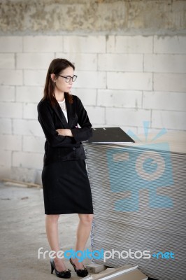 Business Woman Standing Thoughtful In A Building Stock Photo