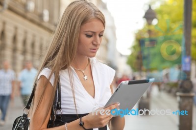 Business Woman With Tablet Computer Walking On Urban Street Stock Photo