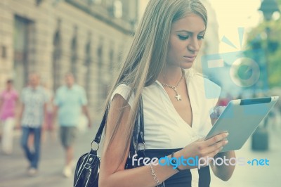 Business Woman With Tablet Computer Walking On Urban Street Stock Photo