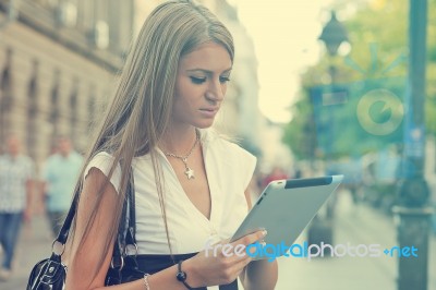 Business Woman With Tablet Computer Walking On Urban Street Stock Photo