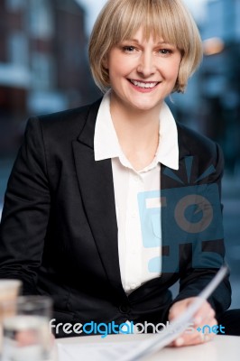 Business Women Reviewing Business Report Stock Photo