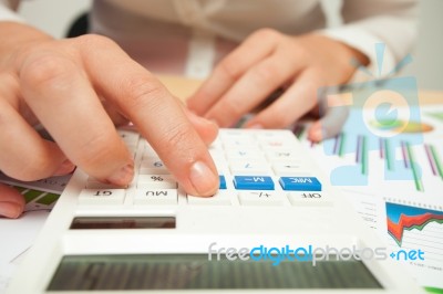 Business Women With Calculator And Financial Charts Stock Photo