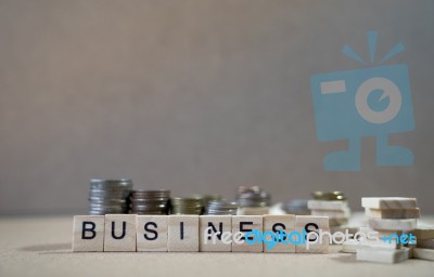 Business Word Written In Wooden Cube On Wood Table With Money Gr… Stock Photo