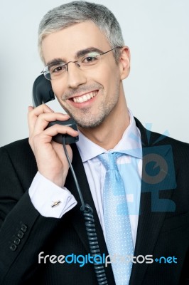 Businessman Answering A Call Stock Photo