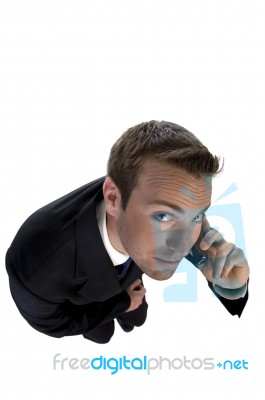 Businessman Busy On Phone Call And Looking Upwards Stock Photo