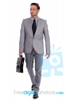 Businessman Carrying Briefcase And Walking Stock Photo