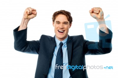 Businessman Celebrating Success With Arms Up Stock Photo