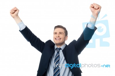 Businessman Celebrating Success With Arms Up Stock Photo