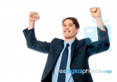 Businessman Celebrating Success With Arms Up Stock Photo