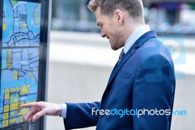 Businessman Checking A Bus Timetable Stock Photo