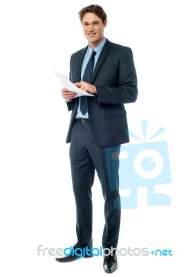 Businessman Checking Data Printed On The List Stock Photo