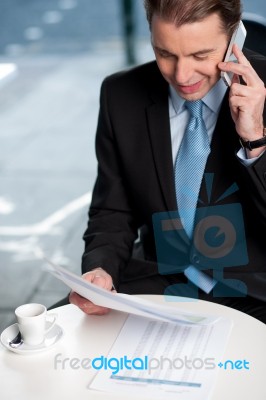 Businessman Communicatng On Phone Stock Photo